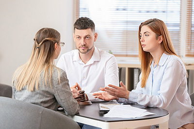 Young couple visiting divorce lawyer in office